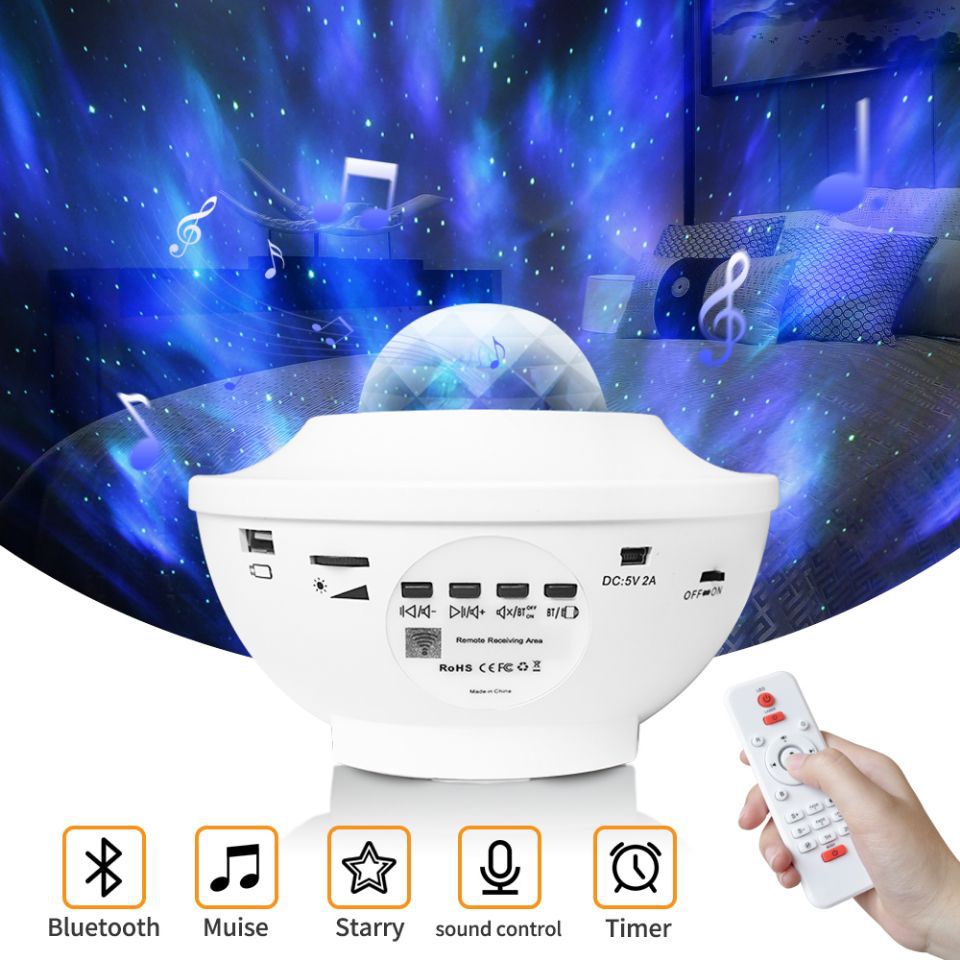 White night light projector with remote control against a starry sky background